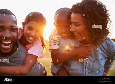 Young black couple enjoying family time with children Stock Photo - Alamy