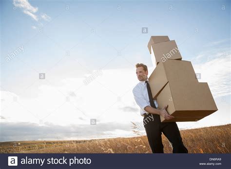 Businessman Carrying Stacked Cardboard Boxes Stock Photo Alamy