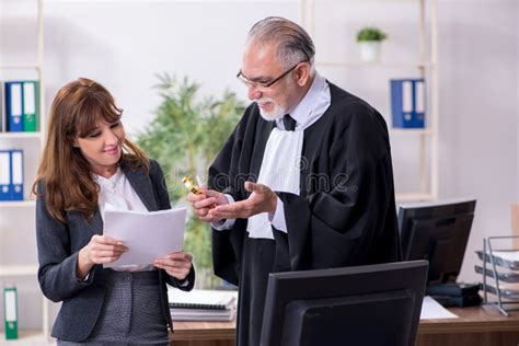 Old Male Judge And His Young Secretary In The Office Stock Image