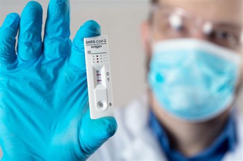 premium photo positive test result   rapid test device  covid