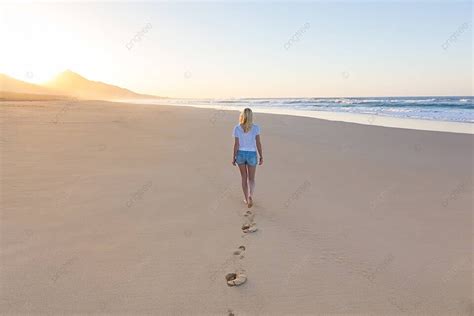 Lady Walking On Sandy Beach In Sunset Footprint Ocean Sea Photo