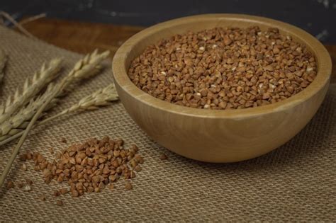 Premium Photo A Bowl Of Oatmeal Sits On A Table Next To A Wheat Spike