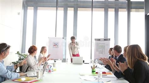 Business People Clapping After Presentation Of Their Colleague Stock