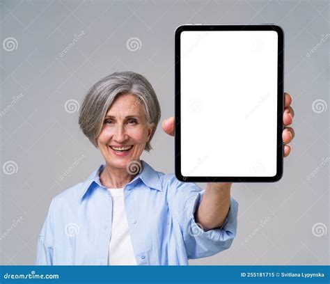 Happy Confident Mature Woman Holding Digital Tablet With White Empty