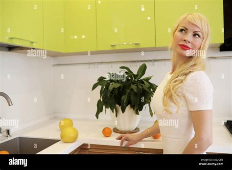 Blonde Girl Posing On Camera Standing In Kitchen Stock Photo Alamy