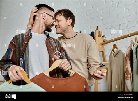 Two Men Members Of A Gay Couple Stand Side By Side In A Designer
