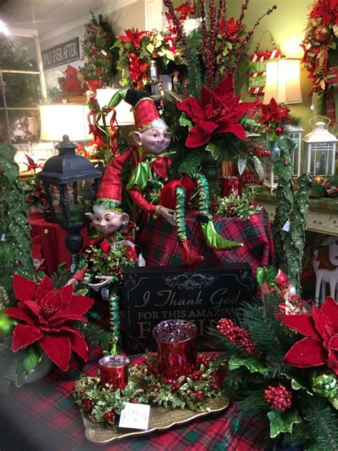 A Christmas Display With Poinsettis And Decorations