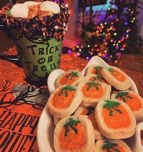 A White Plate Topped With Mini Carrots Next To A Cup Filled With