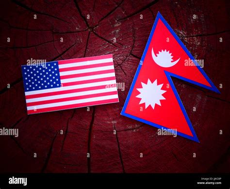Usa Flag With Nepali Flag On A Tree Stump Isolated Stock Photo Alamy