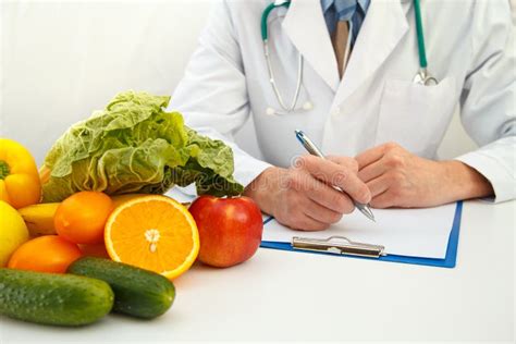 Nutritionist Doctor Writing Diet Plan On The Table Stock Image Image