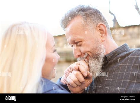 Mature Man Kissing His Wife S Hand Outdoors Stock Photo Alamy