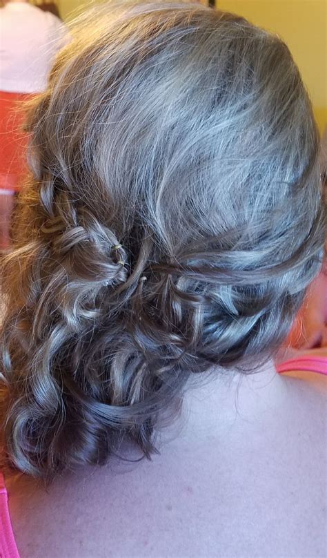 the back of a woman's head, with grey hair in a low bun