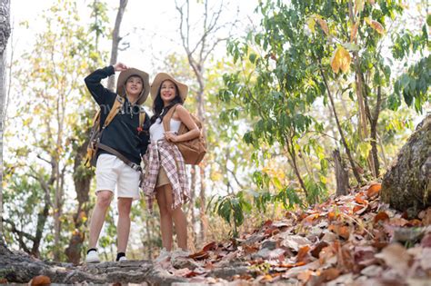 Cheerful Romantic Lesbian Couple Traveler With Backpack On Their Backs Go Hiking Through The
