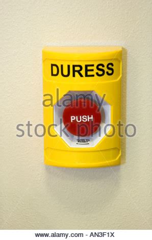 Red duress button on wall Stock Photo - Alamy