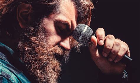 Man With A Beard Holding A Microphone And Singing Bearded Man In