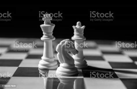 Black And White Shot Of Chess Pieces King Queen And Knight On Chess