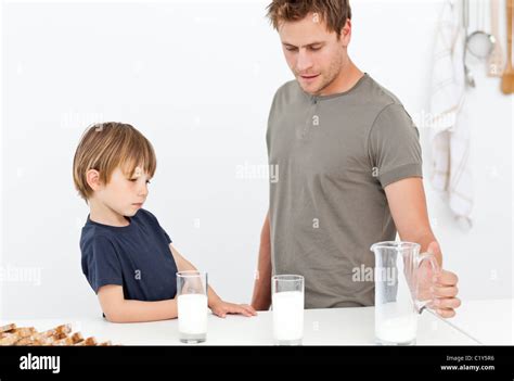 Cute Dad And Son Drinking Milk Together Stock Photo Alamy