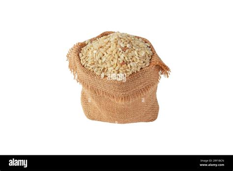 Brown Rice Grain In The Jute Canvas Sack Isolated On White Uncooked