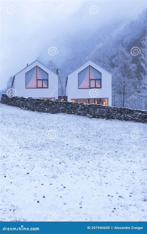 Modern White House With Large Windows Surronded By Nature Snow And Fog