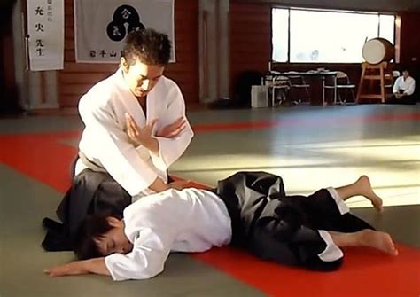 men  black  white uniforms    ground   hands