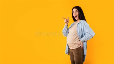 Pregnancy Advertisement Excited Pregnant Woman Pointing Aside At Copy