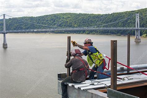 Bridge lift construction workers - Stock Image - C022/7381 - Science Photo Library