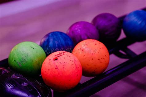 Rack Filled With A Colorful Assortment Of Rainbow Hued Bowling Balls