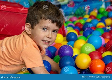 Playground with Ball Pit Indoor. Joyful Kid Having Fun at Indoor Kids ...