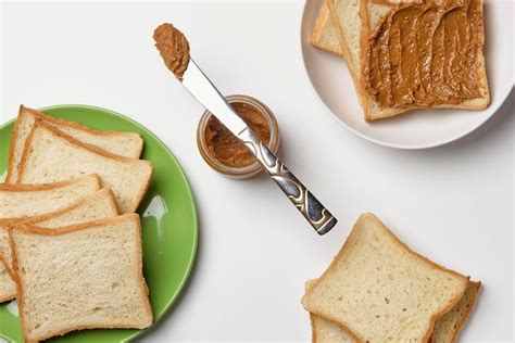 Premium Photo Knife On The Peanut Butter Jar And Fresh Toasts On The