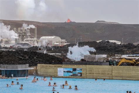 Tourists watch volcano erupt from spa as popular Iceland attraction ...