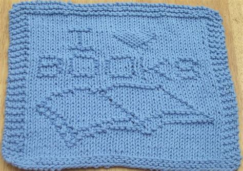 A Crocheted Blue Dishcloth With An Image Of A Boat On The Front