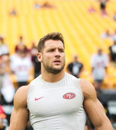 a man standing in front of a football field