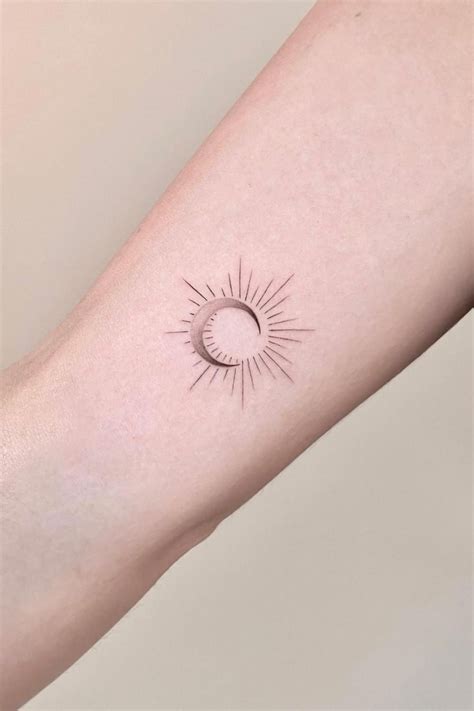 A Small Sun Tattoo On The Arm