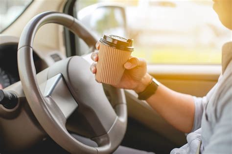 Premium Photo A Driver Drinking Coffee In The Car