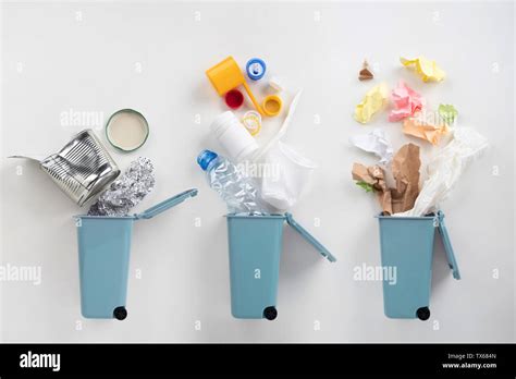 Trash Bins And Assorted Garbage On Grey Background Recycle Concept