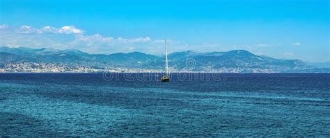 Harbor And Yachts With French Riviera Shore In Background Seen From