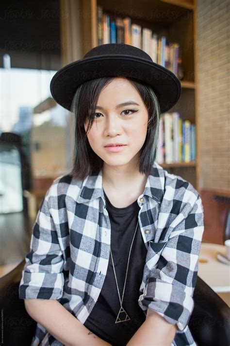 Cute Self Aware Empowered Asian Woman Looking At Camera In Library By