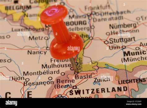 A Red Pin Stuck Into A Map Of Western Europe Pinpointing The Location