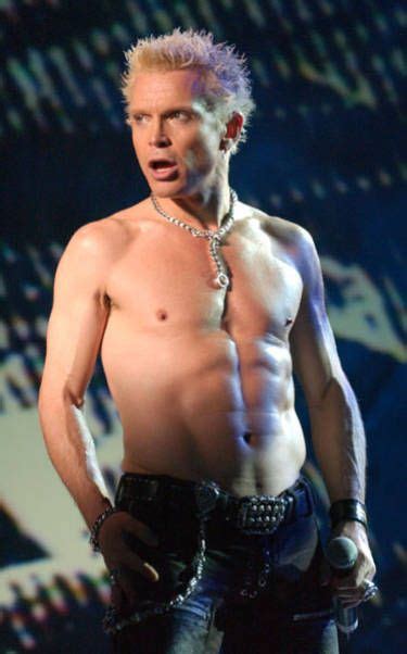 A Shirtless Man Is Standing On Stage With His Hands In His Pockets