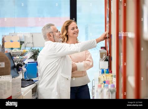 Pharmacist Helping Smiling Customer In Pharmacy Store Stock Photo Alamy