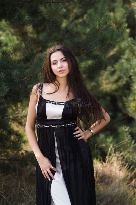 Graceful Charming Brunette Model Posing In Black Dress In Coniferous Park Stock Image Image Of