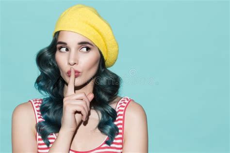 Beautiful Woman In A Yellow Beret Makes A Gesture Of Silence Stock