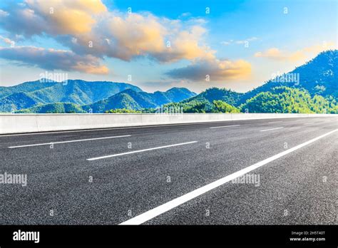 Asphalt Road And Mountain At Sunset Road And Mountain Background Stock