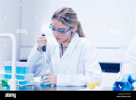 Science student using pipette in the lab Stock Photo - Alamy