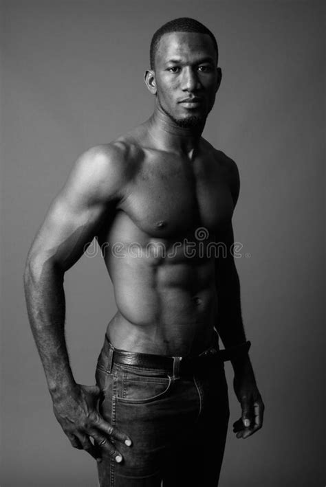 Handsome Muscular African Man Shirtless Against Brown Background Stock