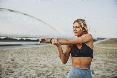 Fit Woman Stretching Her Arm While Working Up Outdoors Training