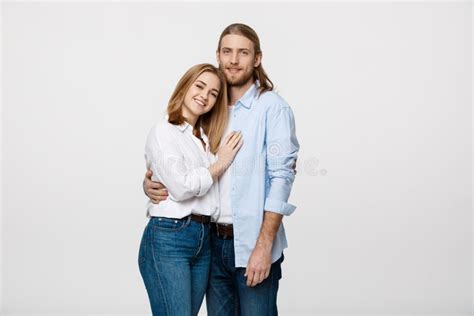 Portrait Of Cheerful Young Couple Standing And Hugging Each Other On