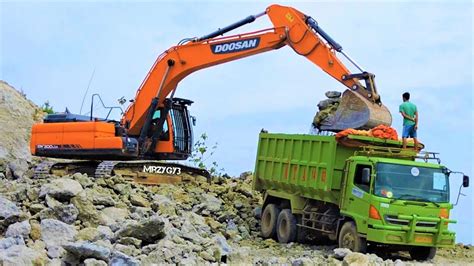 Excavator Loading Dirt Into Dump Truck At The Quarry Doosan DX300LCA