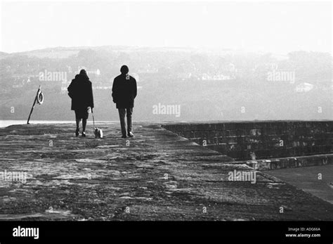 Two People Walking Along A Path B W Stock Photo Alamy