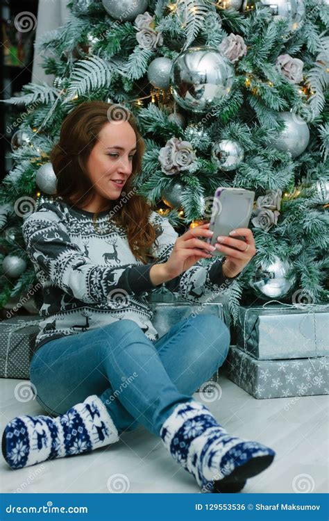 Beautiful Girl Taking A Selfie Photo Near The Christmas Tree Stock